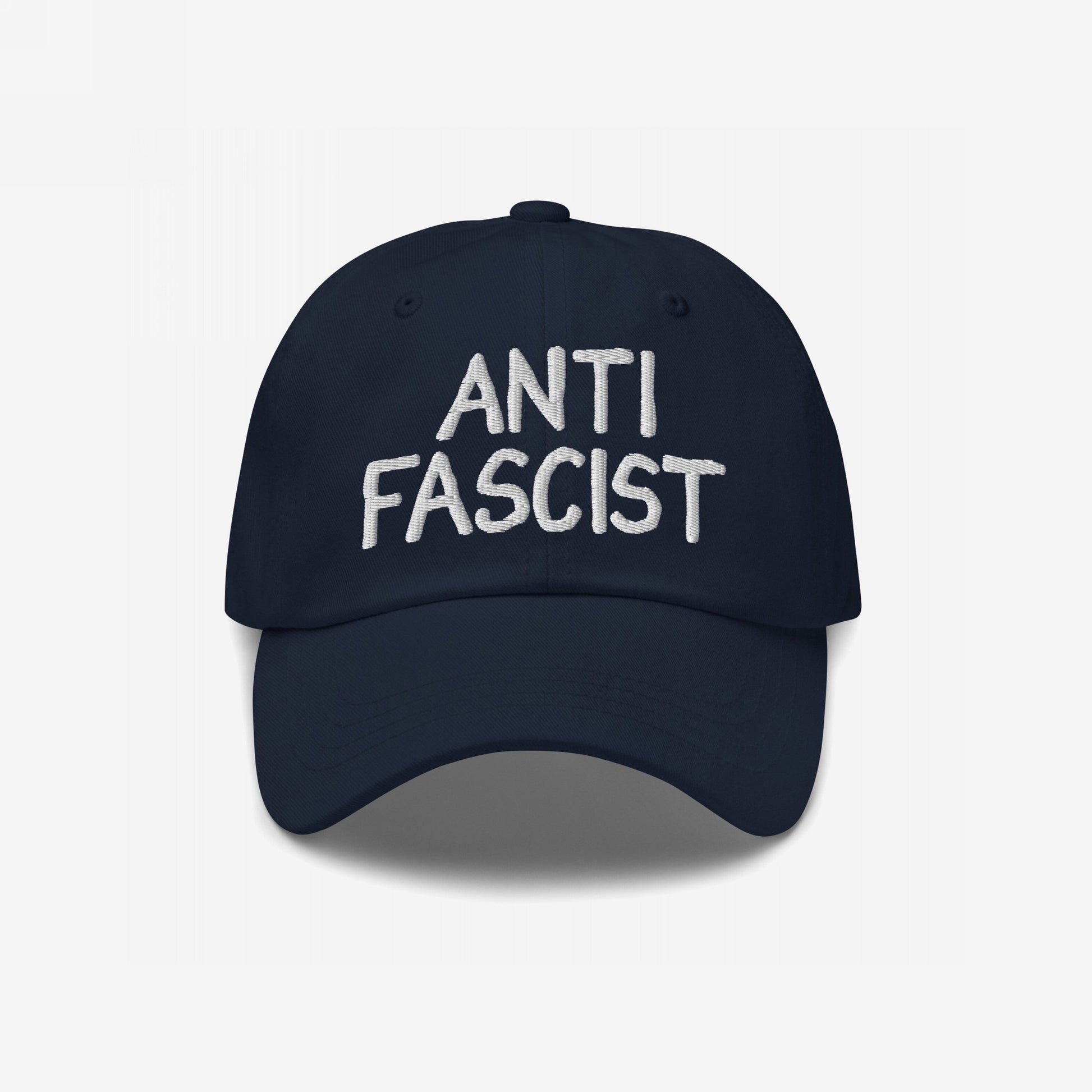 Anti-Fascist Hat with white embroidered text, featuring a soft, navy baseball-style design. This ethically made cap symbolizes resistance, offering a stylish way to express anti-fascist values daily.