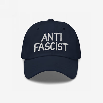 Anti-Fascist Hat with white embroidered text, featuring a soft, navy baseball-style design. This ethically made cap symbolizes resistance, offering a stylish way to express anti-fascist values daily.