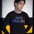 A young person models the Anti-Fascist USA Classic T-shirt, boldly displaying ANTI FASCIST in an American flag motif, embodying resistance and radical pride.