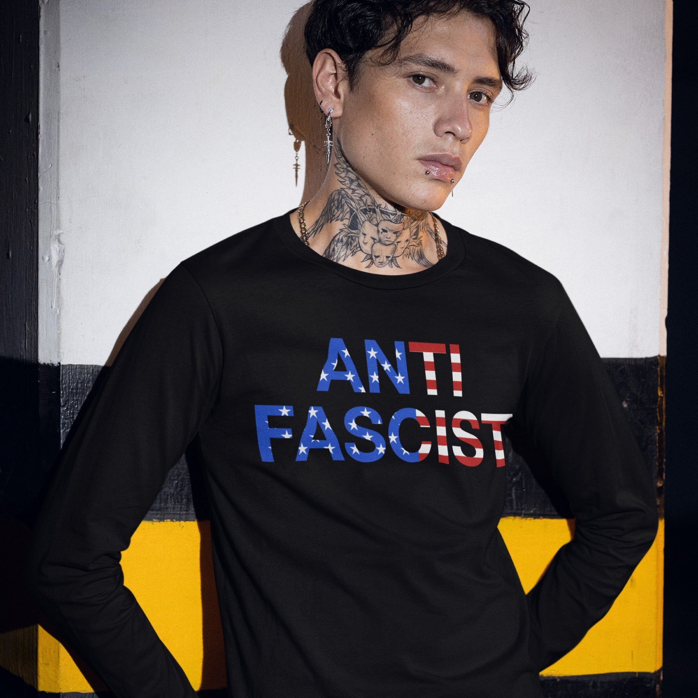 A young person models the Anti-Fascist USA Classic T-shirt, boldly displaying ANTI FASCIST in an American flag motif, embodying resistance and radical pride.