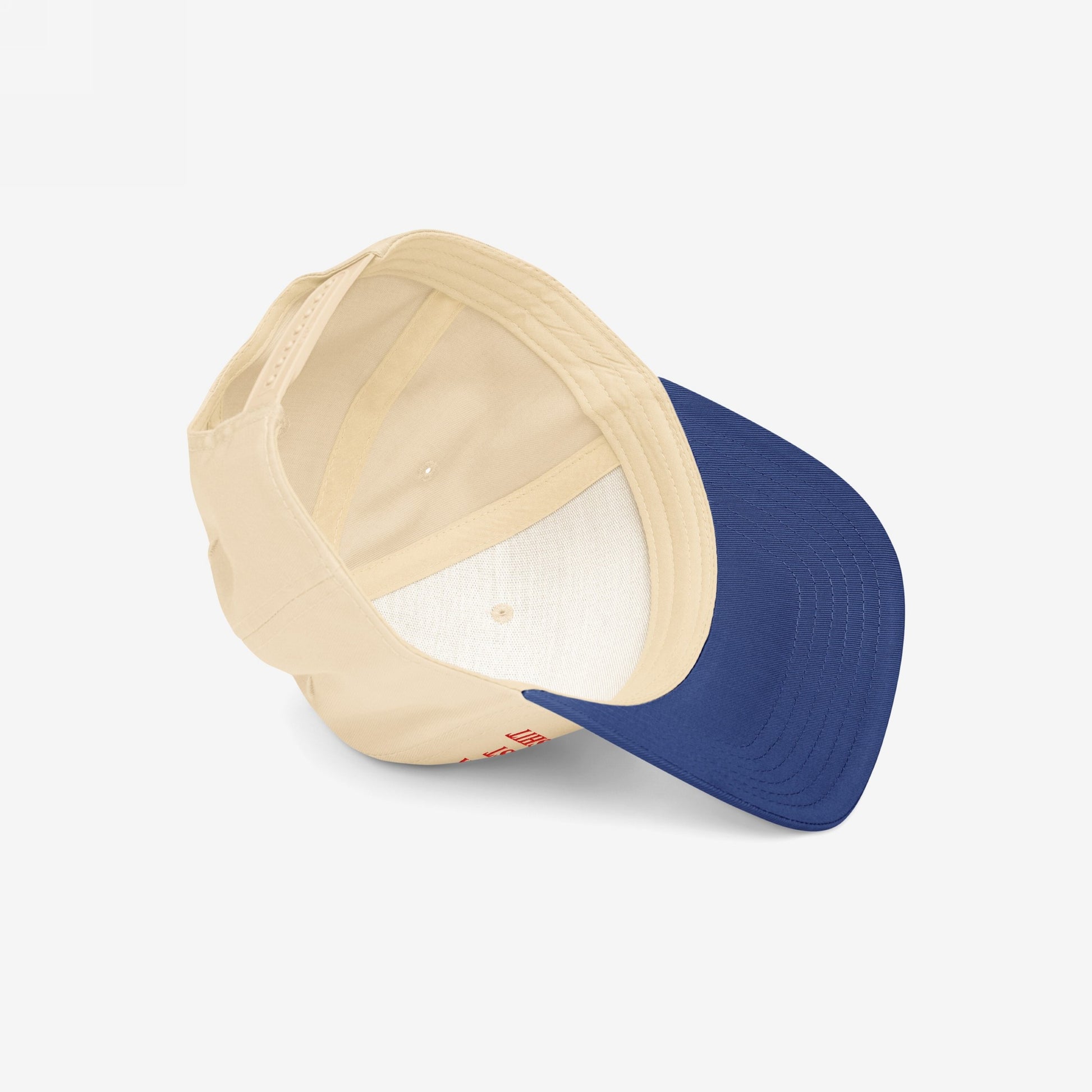 Anti-Fascist Retro 5-Panel Hat: A structured, mid-profile cap with a bold embroidered anti-fascism message, featuring a light beige crown and deep navy visor, viewed from above.