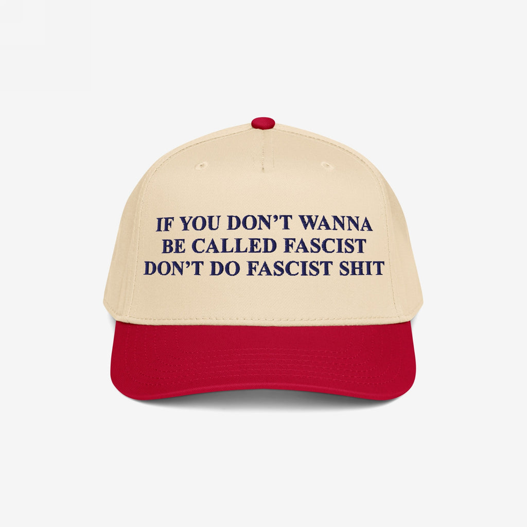 Anti-Fascist Retro 5-Panel Hat featuring bold dark blue lettering on a beige crown and red visor. Embroidered with a powerful anti-fascist message, it combines style and activism with an adjustable fit.