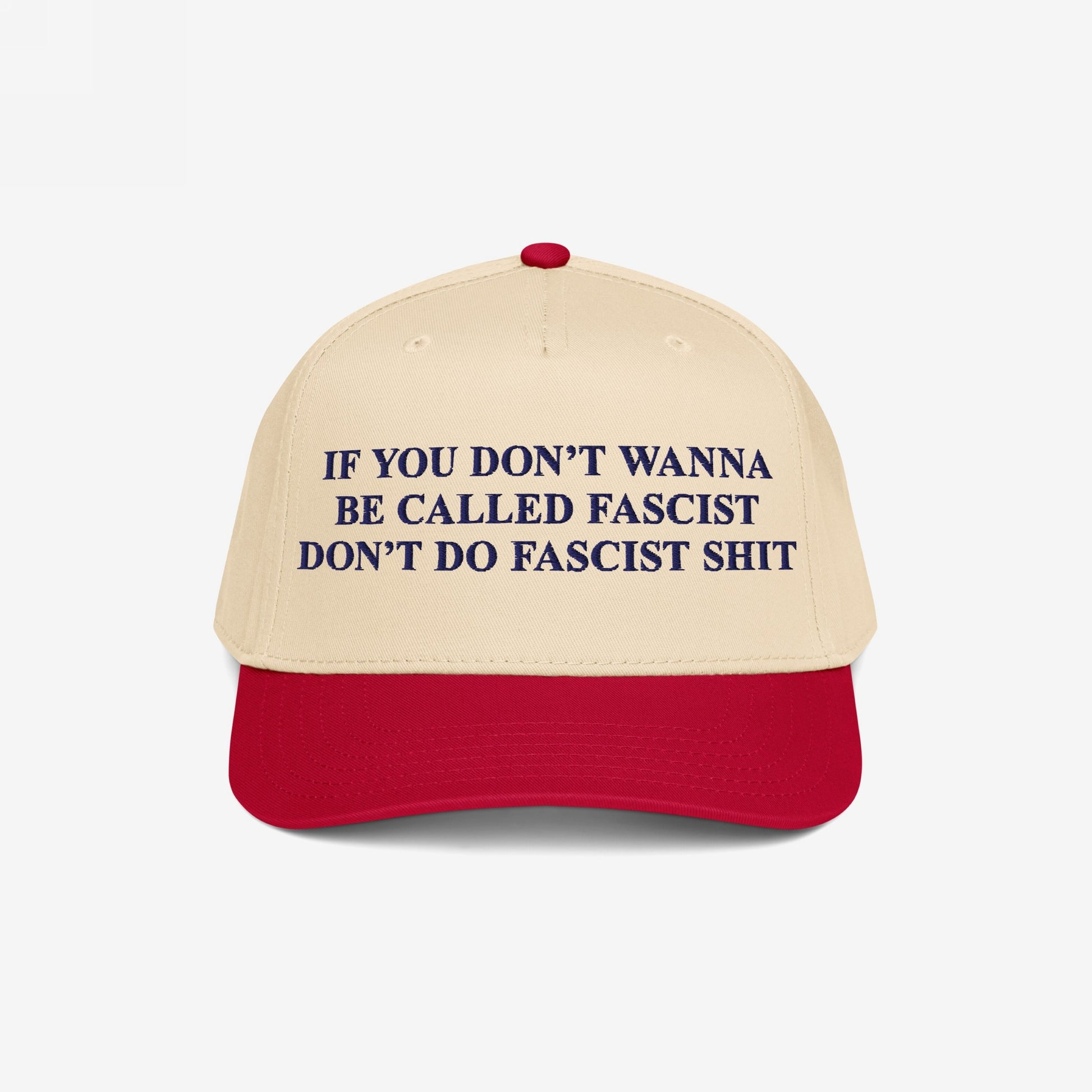 Anti-Fascist Retro 5-Panel Hat featuring bold dark blue lettering on a beige crown and red visor. Embroidered with a powerful anti-fascist message, it combines style and activism with an adjustable fit.
