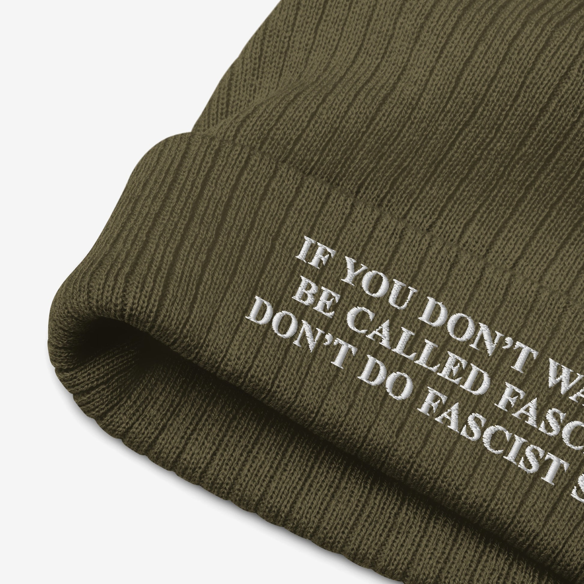Anti-Fascist Retro Beanie: Olive-green ribbed knit beanie with white embroidered text reading IF YOU DON’T WANT TO BE CALLED FASCIST, DON’T DO FASCIST…, showcasing bold resistance style and warmth.