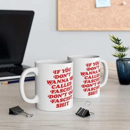 Anti-Fascist Retro Mug: Two white ceramic mugs with bold red text deliver a powerful message against fascism, set on a tidy desk with a laptop, pencil, and potted plant.