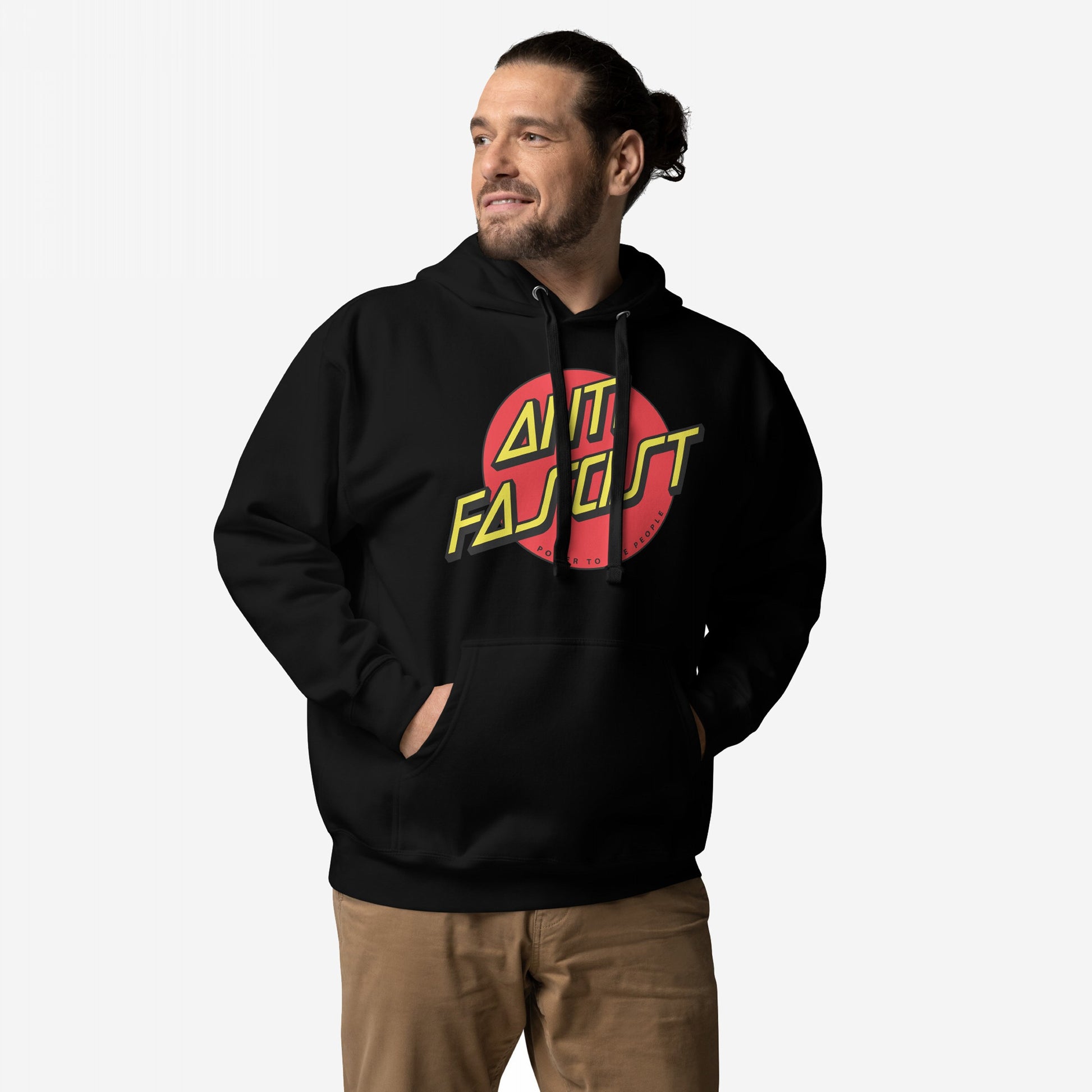 Anti-Fascist Hoodie & Sweatshirt featuring a red circle with bold yellow ANTI FASCIST lettering, worn by a man with hands in the pocket against a light background.