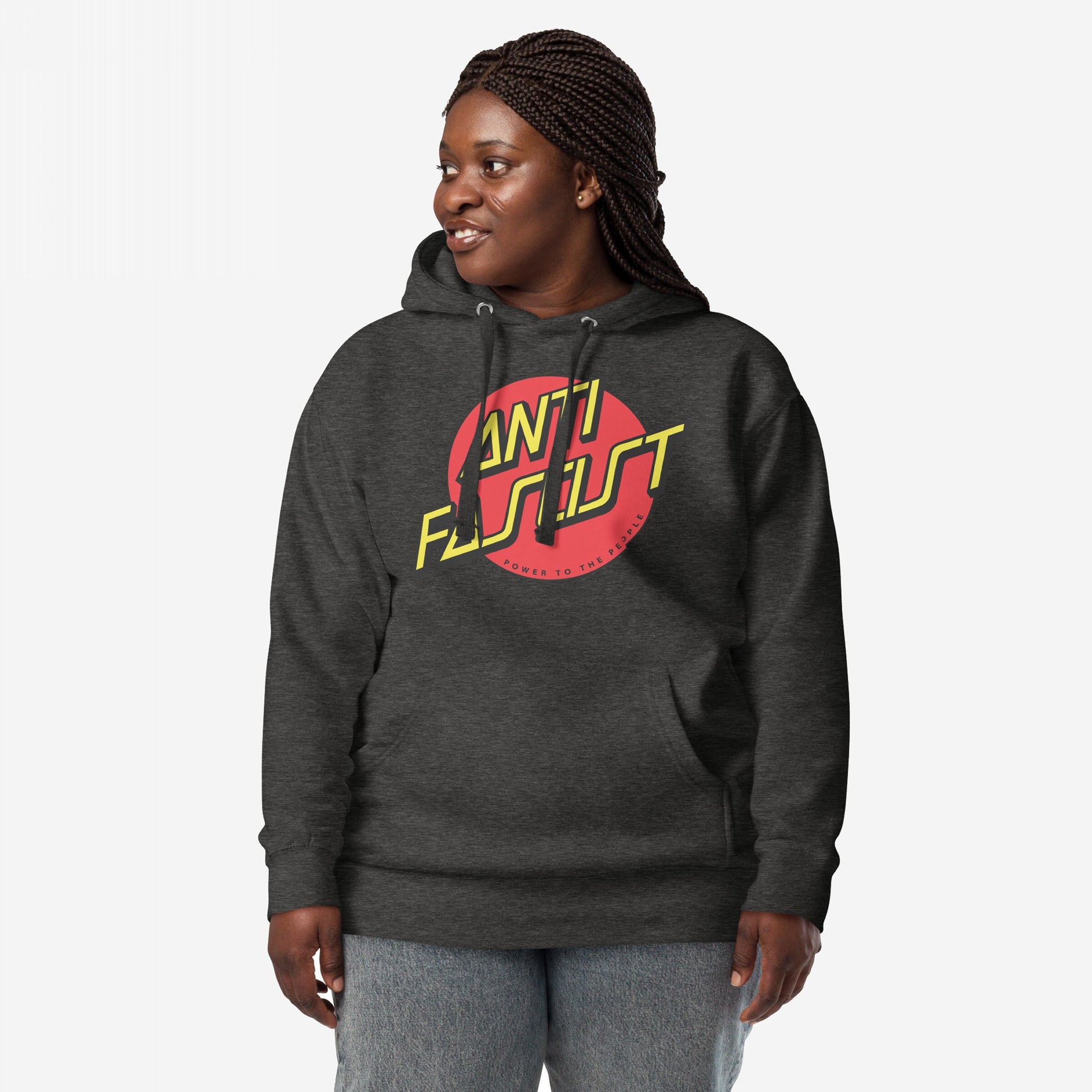 Anti-Fascist Hoodie & Sweatshirt featuring a bold ANTI FASCIST logo in yellow and red, worn by a person with braided hair, reflecting a street-punk style and political message.