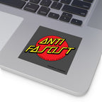 The image shows the palm-rest area of a silver laptop with an Anti Fascist Sticker & Magnet featuring a red circle and bold yellow text promoting progressive values and equality.