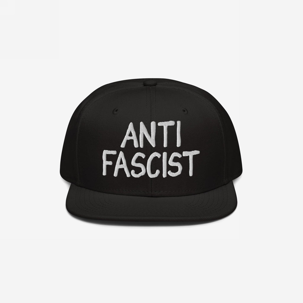 Anti Fascist Hat featuring white embroidery on a black flat-brimmed cap, embodying a bold statement against fascism. Designed for comfort, ethically made, and supports ACLU. Unisex style with a revolutionary flair.