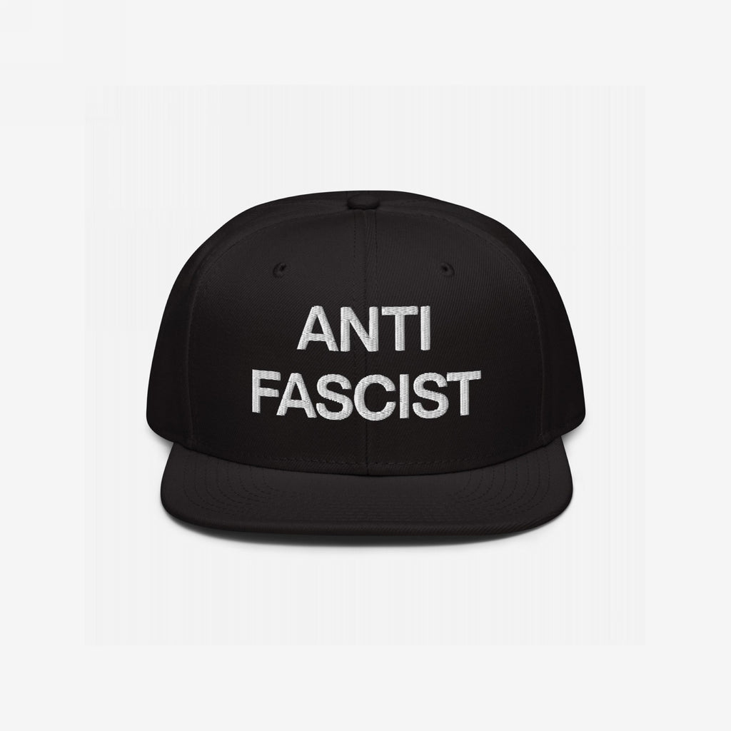 Black flat-bill cap with “ANTI FASCIST” in white block letters, embodying the Anti-Fascist Classic Hat's bold message and timeless style for those committed to resisting fascism.