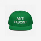 Anti-Fascist Classic Hat: Green snapback with ANTI FASCIST in bold white embroidery, embodying resistance and conviction. Perfect for those advocating against fascism with straightforward style and integrity.