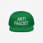 Green flat-brim snapback hat with ANTI FASCIST embroidered in white on the front, embodying a bold statement against fascism. Ethically made for everyday comfort and style. Supports ACLU.