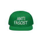 Green flat-brim snapback hat with ANTI FASCIST embroidered in white on the front, embodying a bold statement against fascism.