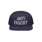 Navy-blue flat-brim snapback hat with ANTI FASCIST in white embroidery, reflecting a bold, unisex statement for those opposin