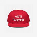 The Anti-Fascist Classic Hat features bold white embroidery stating ANTI FASCIST on a red flat-brimmed baseball cap, embodying a strong, unapologetic stance against fascism with clean, striking lettering.
