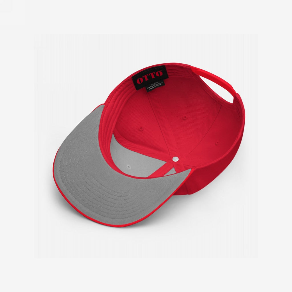 The Anti-Fascist Classic Hat features a red six-panel design, visible from underneath. It includes a gray underside brim, sewn-in OTTO label, and adjustable strap, embodying a bold, timeless style.