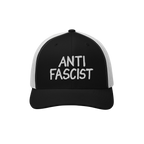 Anti Fascist Hat with a black front and white mesh back, featuring “ANTI FASCIST” embroidered boldly in white, embodies a