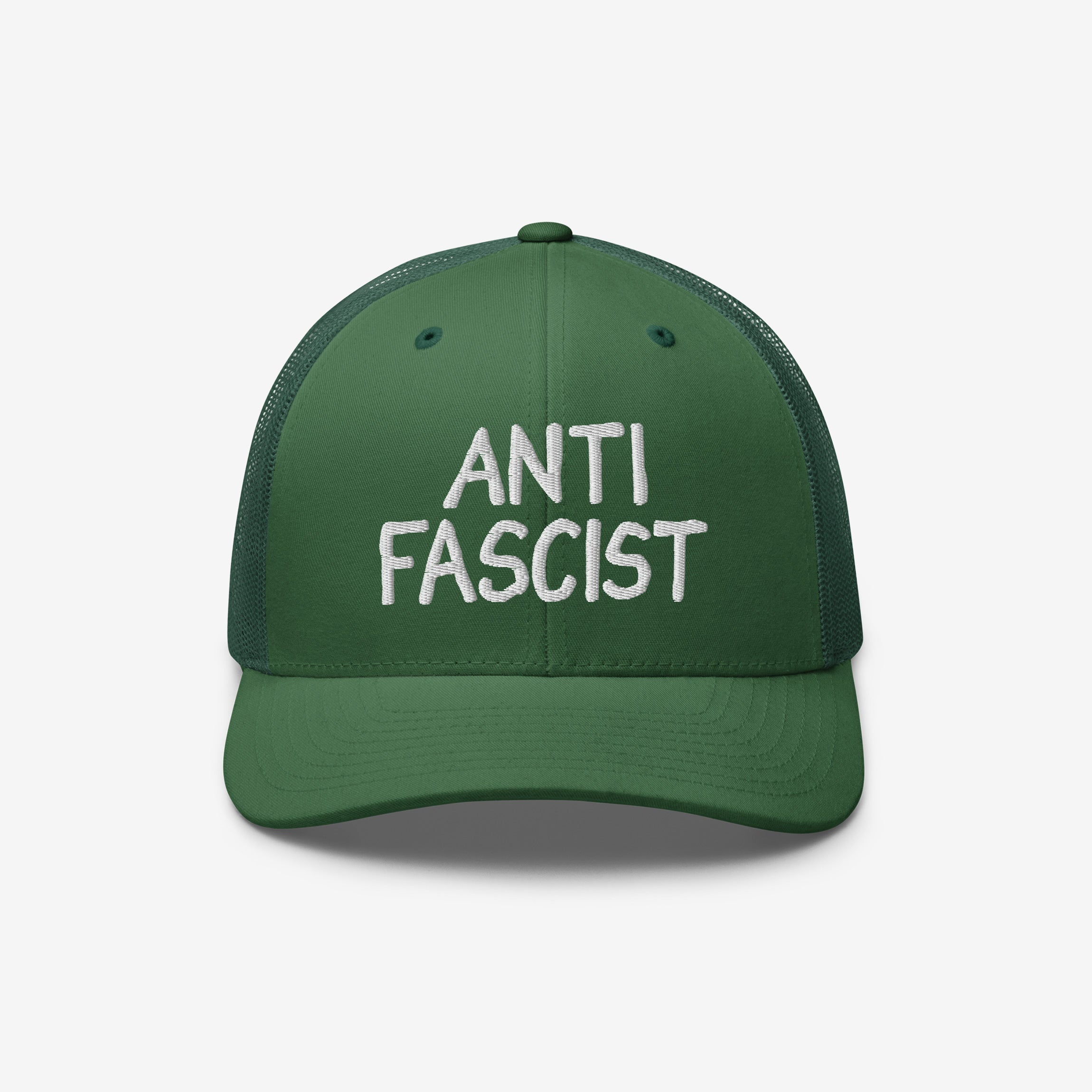 Green mesh-back trucker cap with a solid front panel, featuring ANTI FASCIST in bold white embroidery, symbolizing resistance and ethical production. A unisex statement piece supporting ACLU's mission for justice.