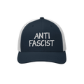 Navy-blue and white mesh trucker hat with “ANTI FASCIST” embroidered on the front, embodying style and resistance. Unisex