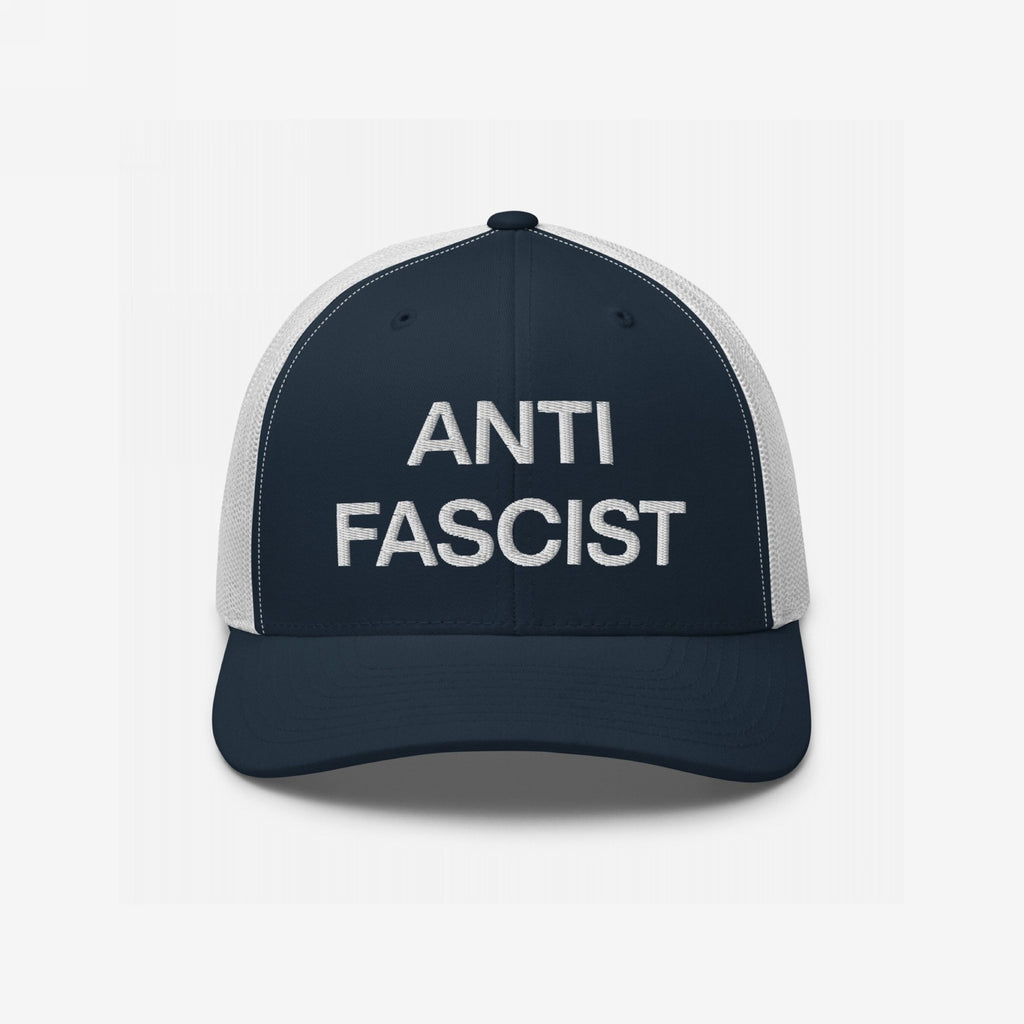 Anti-Fascist Classic Hat: Trucker-style cap with navy front and white mesh back, featuring ANTI FASCIST in bold white embroidery, embodying resistance and timeless style.