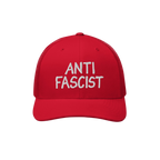 Red trucker-style Anti Fascist Hat with white ANTI FASCIST embroidery on the front, solid front panel, curved brim, and mesh 
