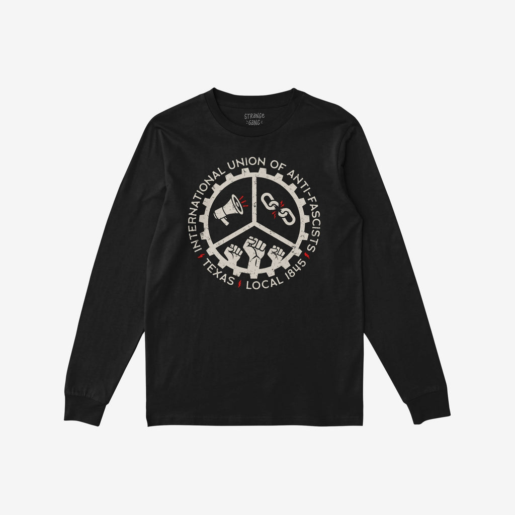 Texas Anti-Fascist Union T-shirt features a circular emblem with a megaphone, broken chain, and raised fists, surrounded by text “INTERNATIONAL UNION OF ANTI-FASCISTS” and “TEXAS • LOCAL 1845.”