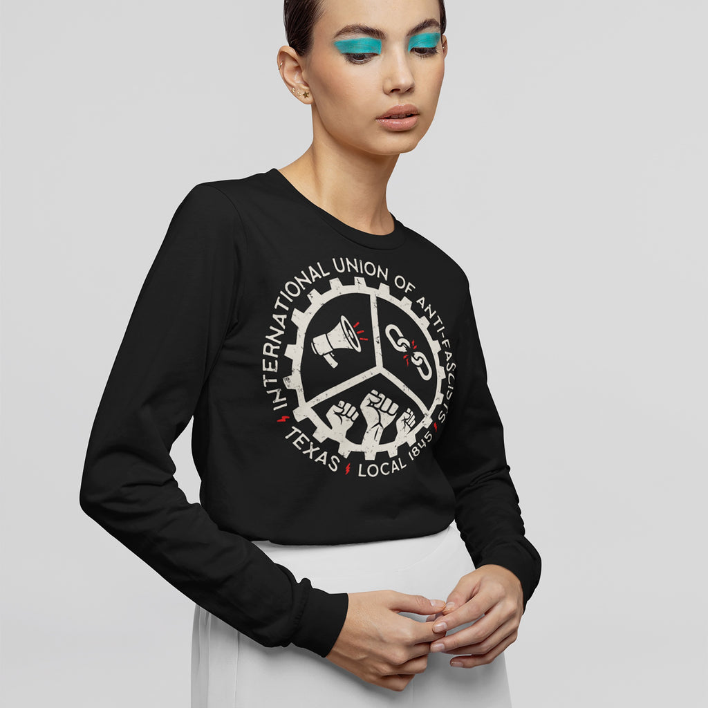 Model wearing Custom Anti-Fascist Union Long Sleeve T-shirt, featuring a distressed gear graphic with icons of a megaphone, broken chain, and fists, symbolizing activism and solidarity.