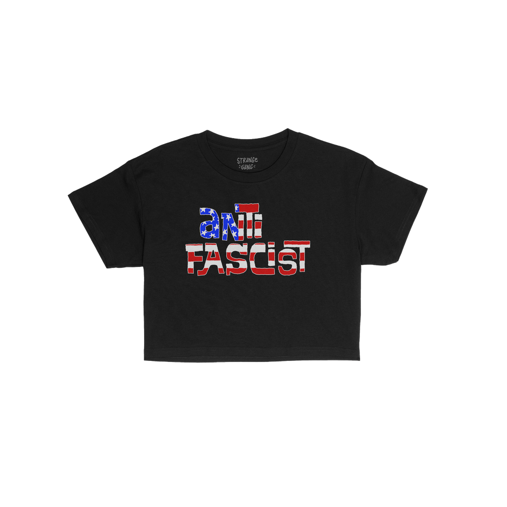 Anti-Fascist USA Women's Baby Tee features “ANTIFASCIST” in stencil-style letters with a distressed U.S. flag motif, symb