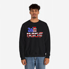 Young man wearing the Anti Fascist USA Shirt, a black crewneck sweatshirt with anti fascist in American-flag patterned letters, paired with light-wash blue jeans, symbolizing resistance and patriotism.