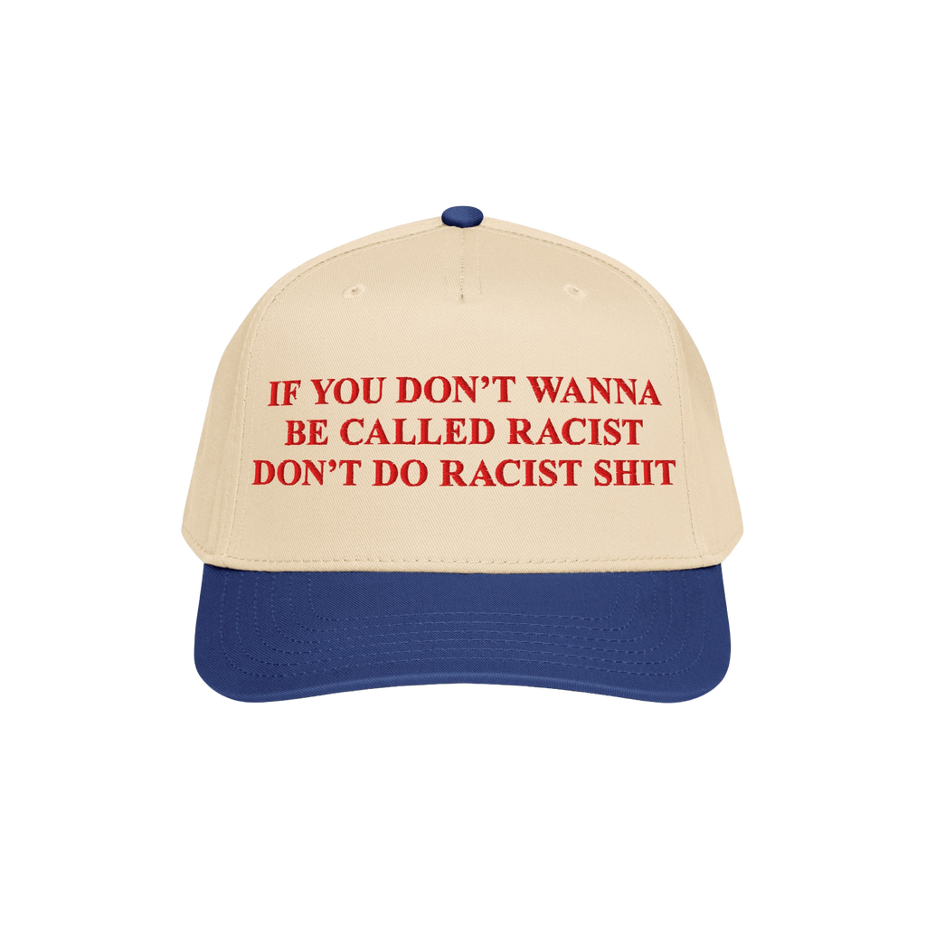 Anti-Racist Hat with bold red slogan on a light tan crown and royal blue bill, challenging racist behavior with unapologetic 
