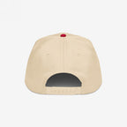 Anti-Racist Hat, back view: six-panel snapback with adjustable closure. Light beige with a red top button, embodying a bold statement against racism, photographed on a white background.