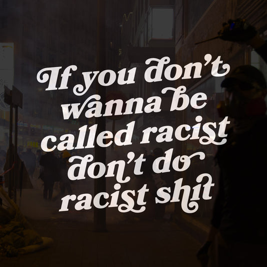 Anti-Racist Shirt with bold message overlay: “If you don’t wanna be called racist, don’t do racist shit,” set against a smoky street scene with people in protest gear, embodying activism and equality.