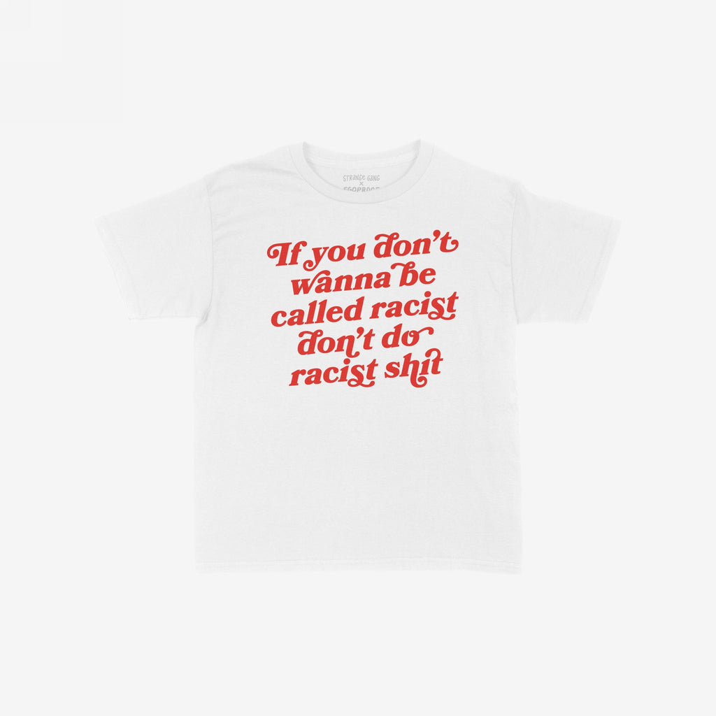 Anti-Racist Women's Baby Tee EU features bold red text urging against racism, embodying a fierce, retro style. This cropped tee delivers a powerful message, perfect for making a statement.
