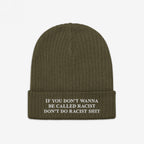 Olive-green Anti-Racist Hat with ribbed knit texture and folded cuff, featuring a bold, embroidered slogan against racism in white block letters, promoting equality and challenging prejudices.