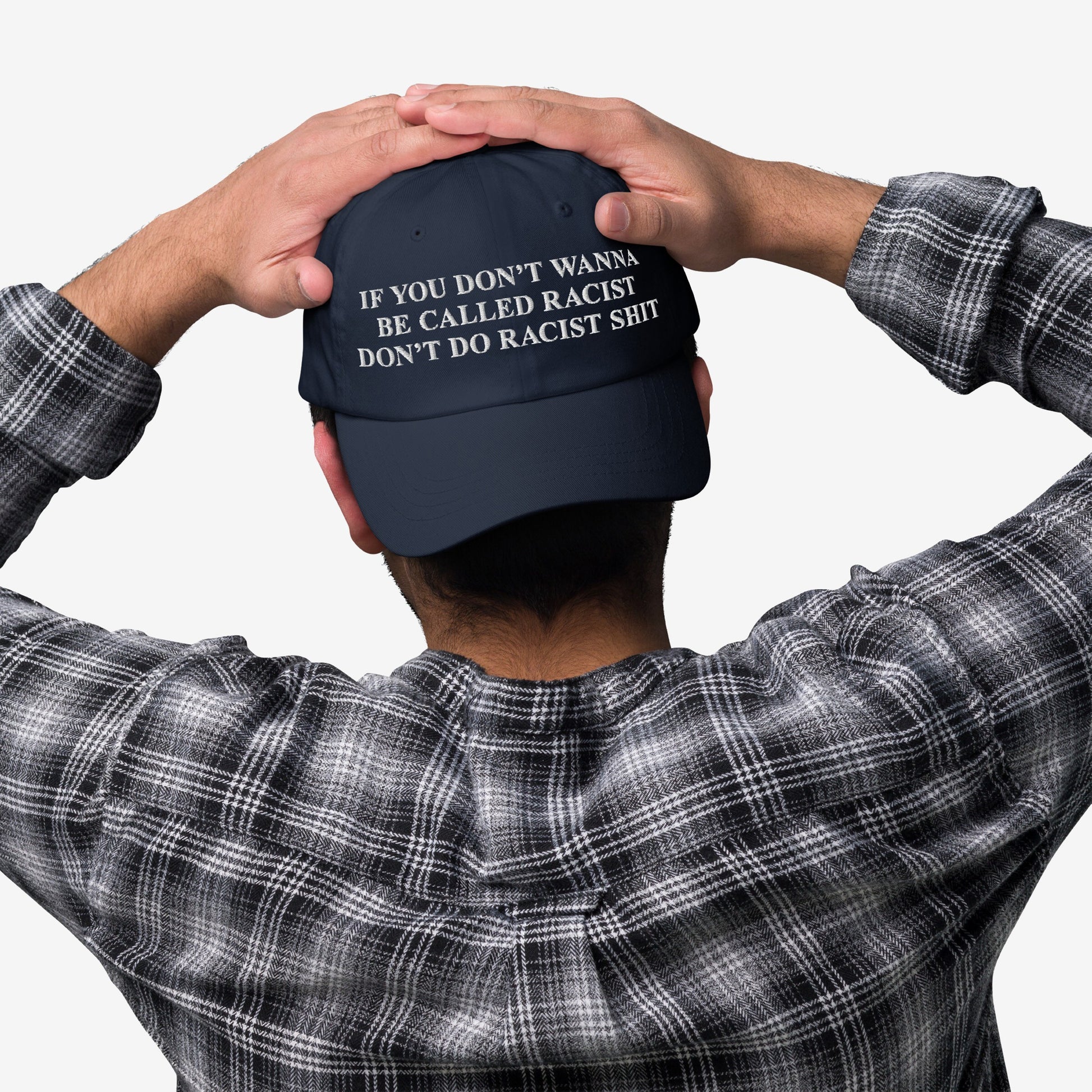 Person wearing an Anti-Racist Hat with an impactful message against racism, embroidered in bold white text, emphasizing a strong stance on equality and truth.