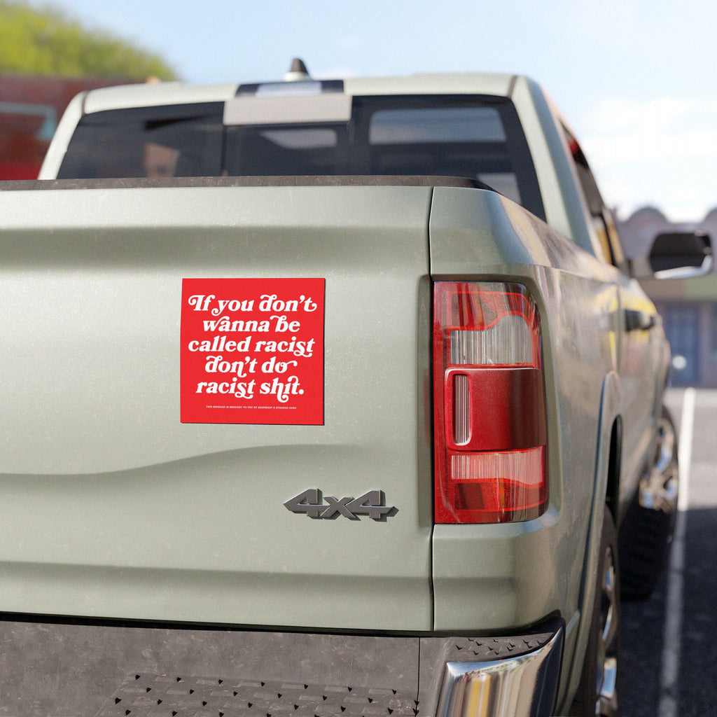 Anti-Racist Sticker & Magnet on a light green 4×4 pickup tailgate, boldly displaying the message against racism in red-and-white, aligned with the store's advocacy for equality and justice.