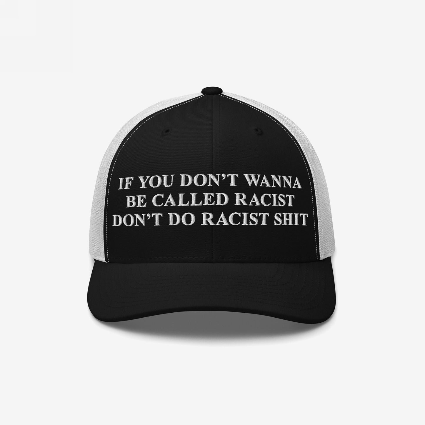 Anti-Racist Hat featuring bold white embroidered text on a black-and-white trucker cap. The message strongly opposes racism, inviting wearers to take a clear, outspoken stance against racial discrimination.