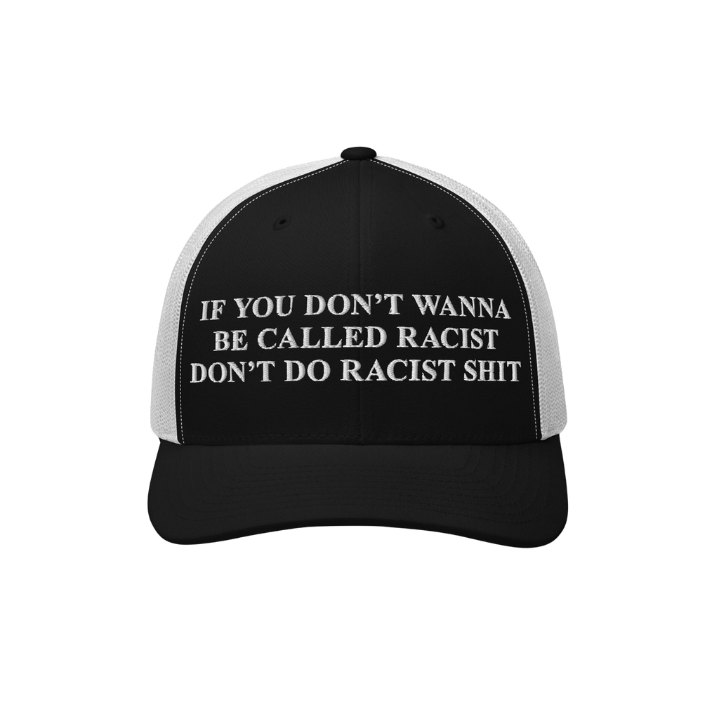 Anti-Racist Hat featuring bold white embroidered text on a black-and-white trucker cap. The message strongly opposes racism, 