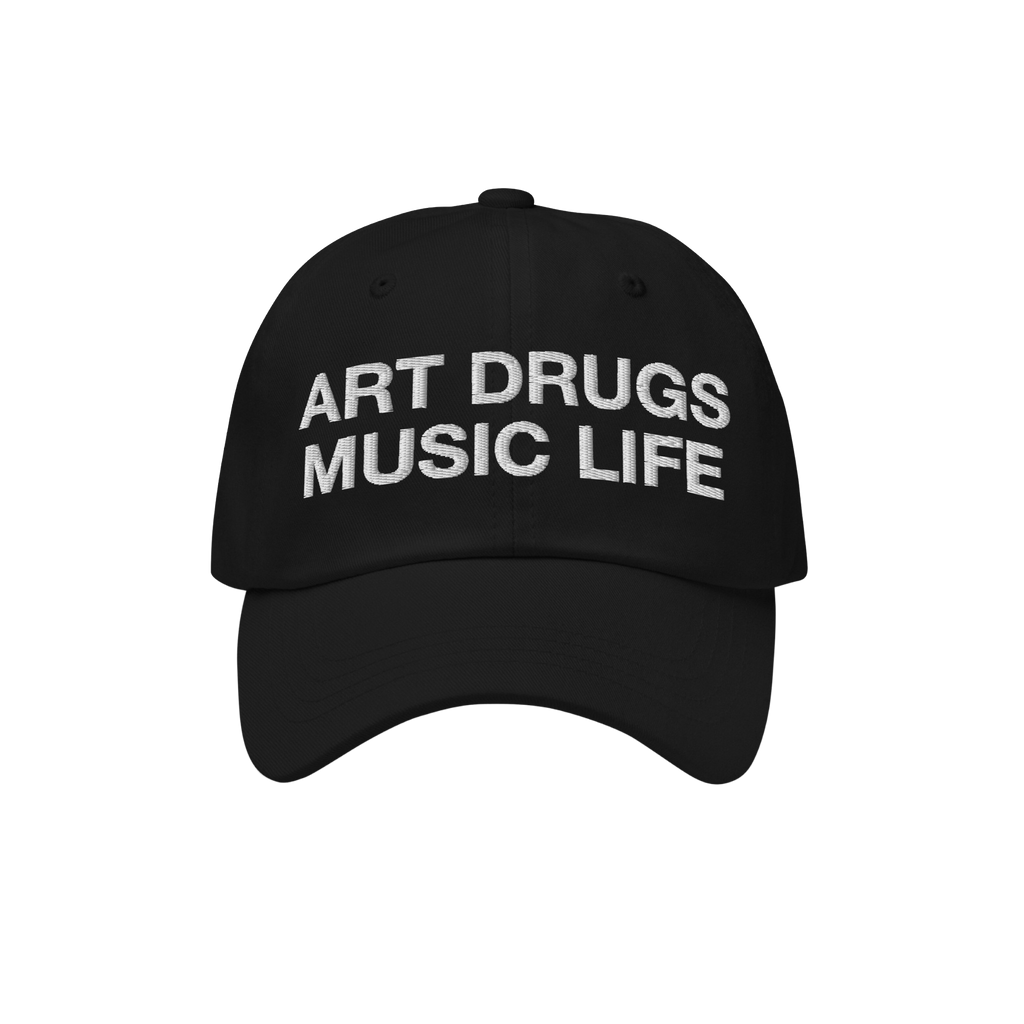 Black dad hat with the bold phrase ART DRUGS MUSIC LIFE embroidered in white, reflecting a manifesto for creativity and expre