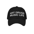 Black dad hat with the bold phrase ART DRUGS MUSIC LIFE embroidered in white, reflecting a manifesto for creativity and expre