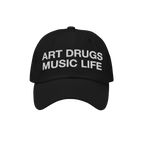 Black dad hat with the bold phrase ART DRUGS MUSIC LIFE embroidered in white, reflecting a manifesto for creativity and expre