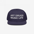 The Art Drugs Music Life Hat features bold white embroidery, declaring creativity and chaos with its mantra on a dark navy-blue snapback, embodying a rebellious spirit through art and music.