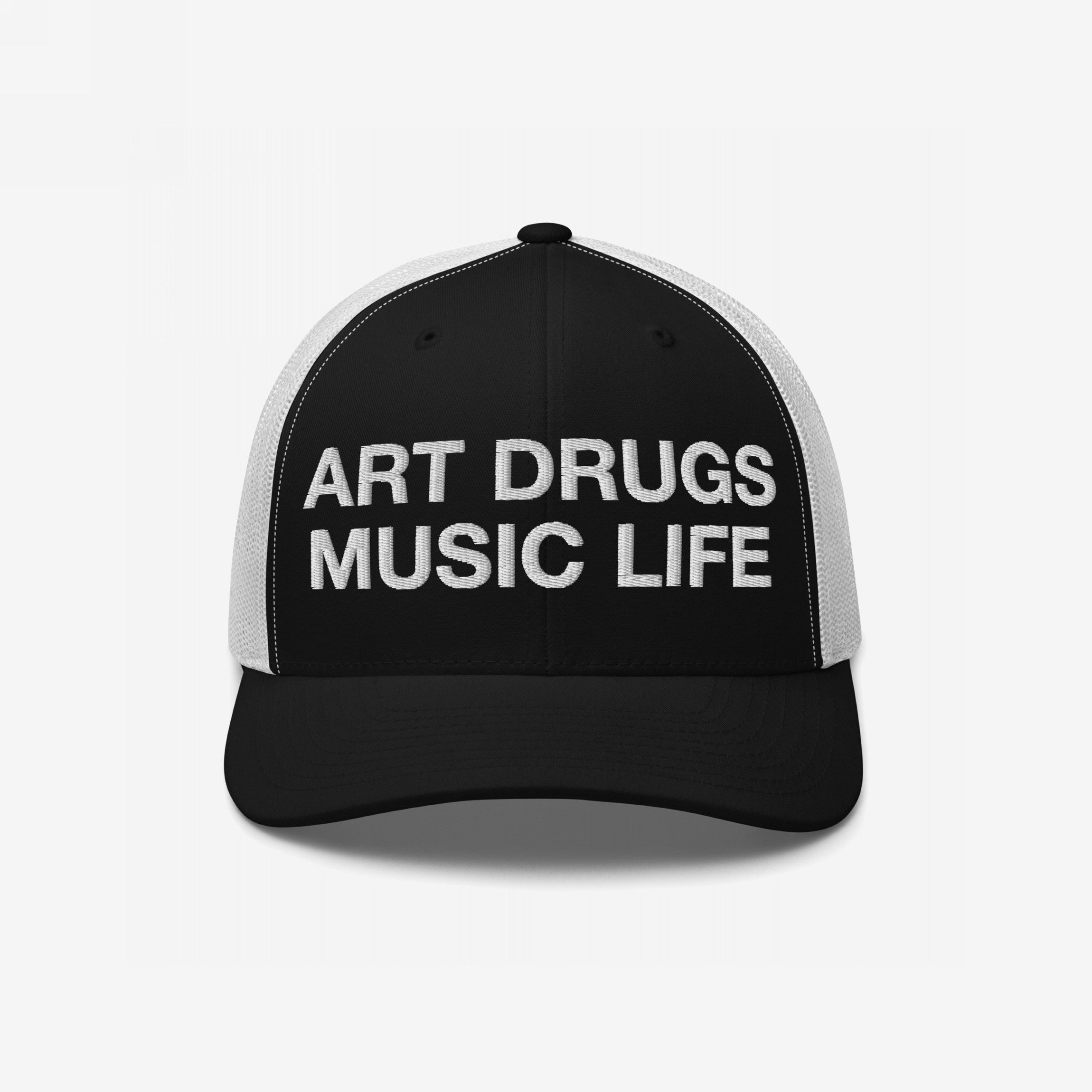 Art Drugs Music Life Hat showcases a black trucker cap with a bold white slogan on the front, embodying a spirit of creativity and expression for those embracing art, chaos, and sound.