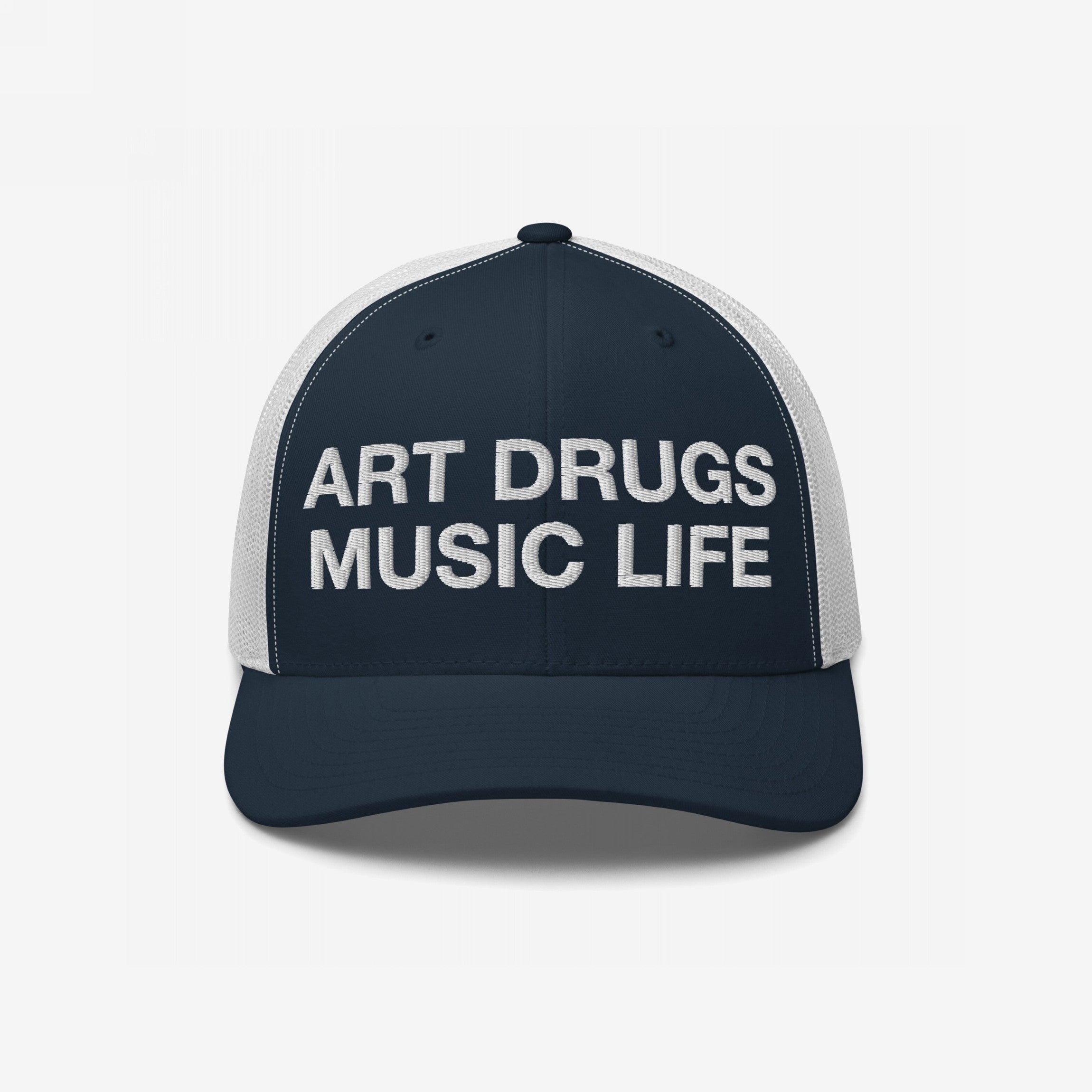 Art Drugs Music Life Hat: Navy trucker cap with bold white embroidery. Front reads “ART DRUGS MUSIC LIFE” in block letters, ideal for creative spirits embracing expression and experience. White mesh back adds comfort.