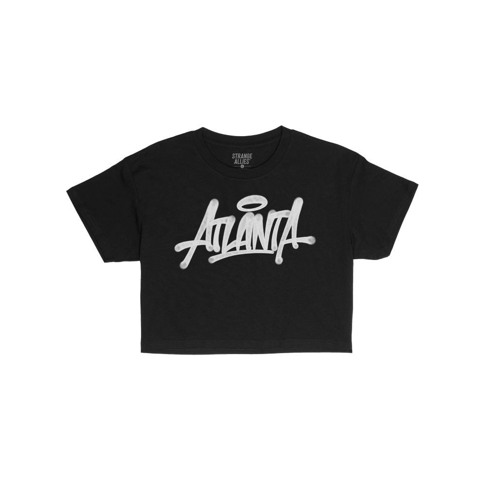 Atlanta Handstyle Women's Baby Tee featuring bold white graffiti-style Atlanta script with a halo, laid against a white backg