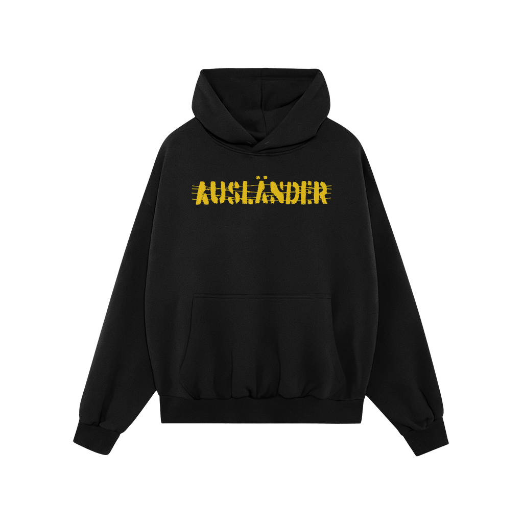 Ausländer Hoodie featuring “AUSLÄNDER” in yellow with a strikethrough, embodies power and resilience. The black pullove