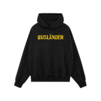 Ausländer Hoodie featuring “AUSLÄNDER” in yellow with a strikethrough, embodies power and resilience. The black pullove