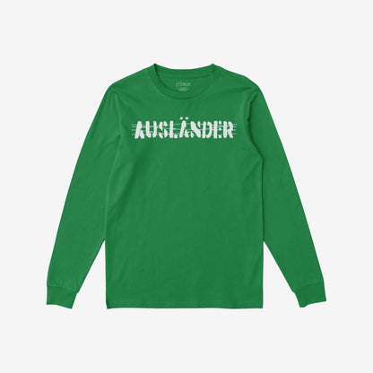 The Ausländer T-shirt features a striking distressed white graphic of AUSLÄNDER on a solid green long-sleeve, embodying a bold message of defiance and inclusivity for outsiders and rebels.
