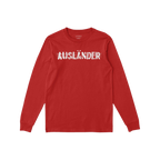 Red long-sleeved Ausländer T-shirt with white, distressed strikethrough lettering across the chest; embodies defiance and so