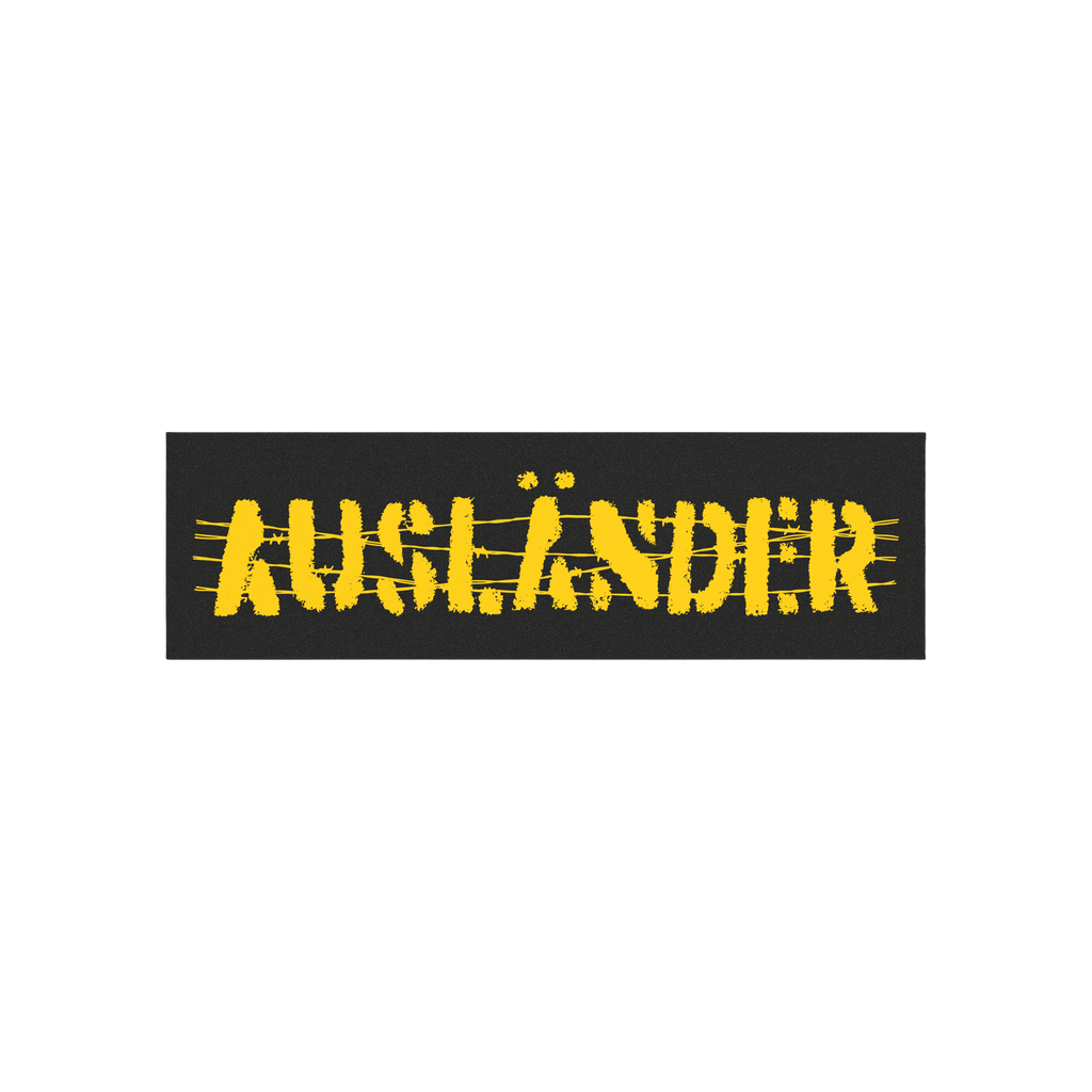 Ausländer Sticker & Magnet featuring a distressed, stencil-style AUFZÄNDER design on a black banner. The background shows a